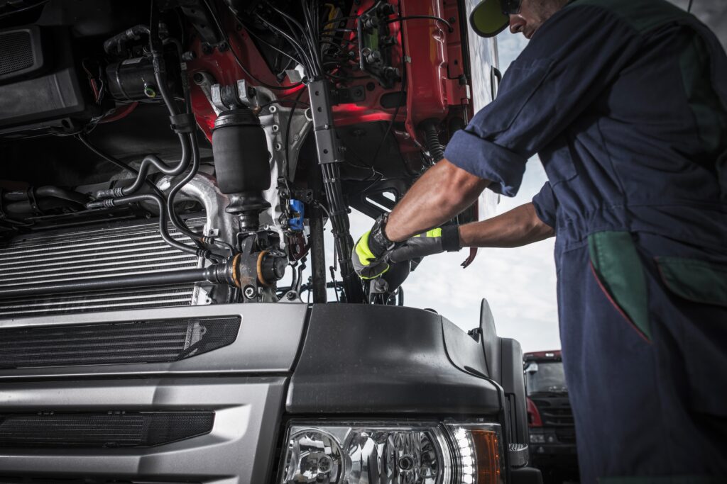Service mechanic working on commercial vehicle